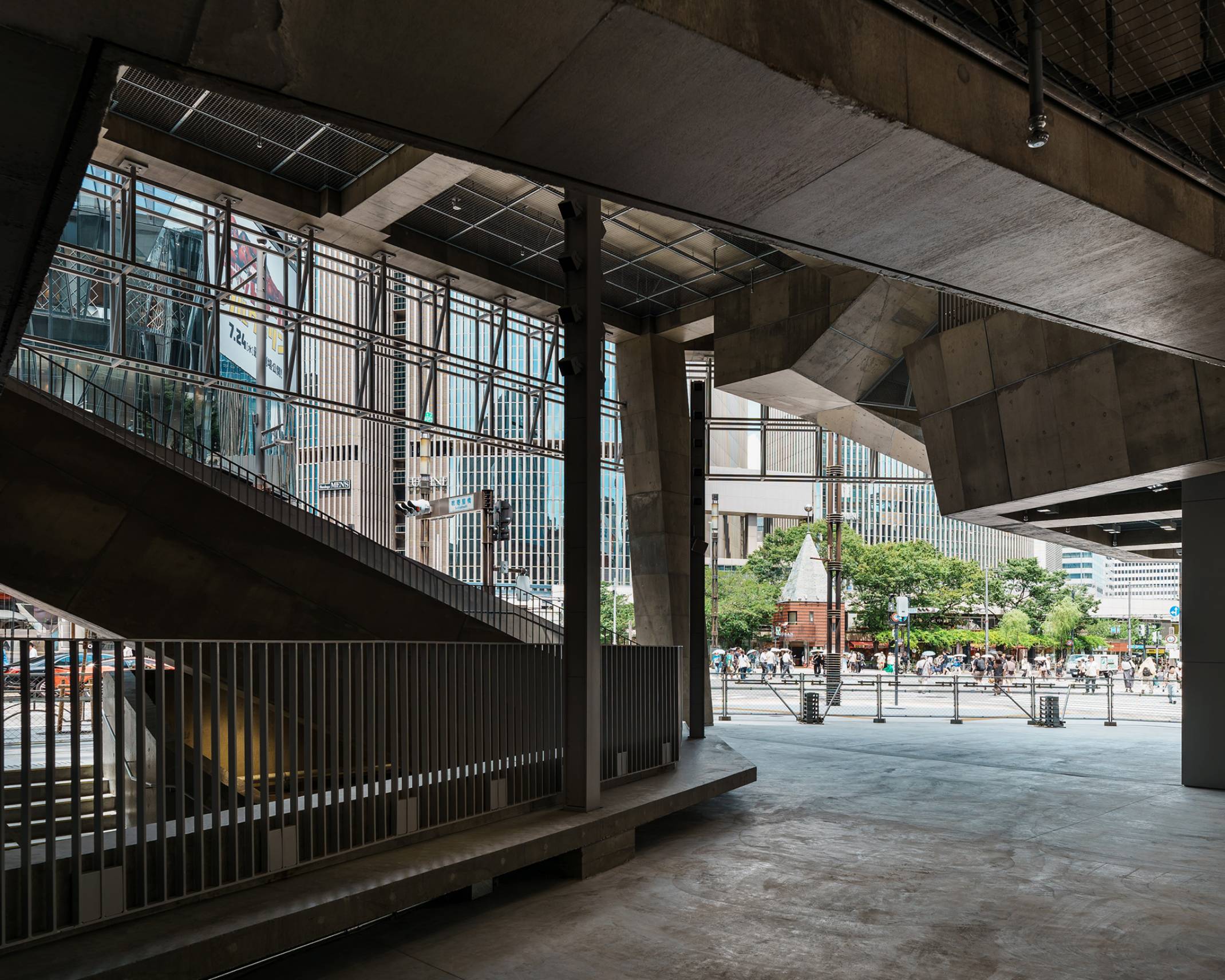 Interior. The atrium space, surrounded by concrete staircases, connects seamlessly into Sukiyabashi Crossing.