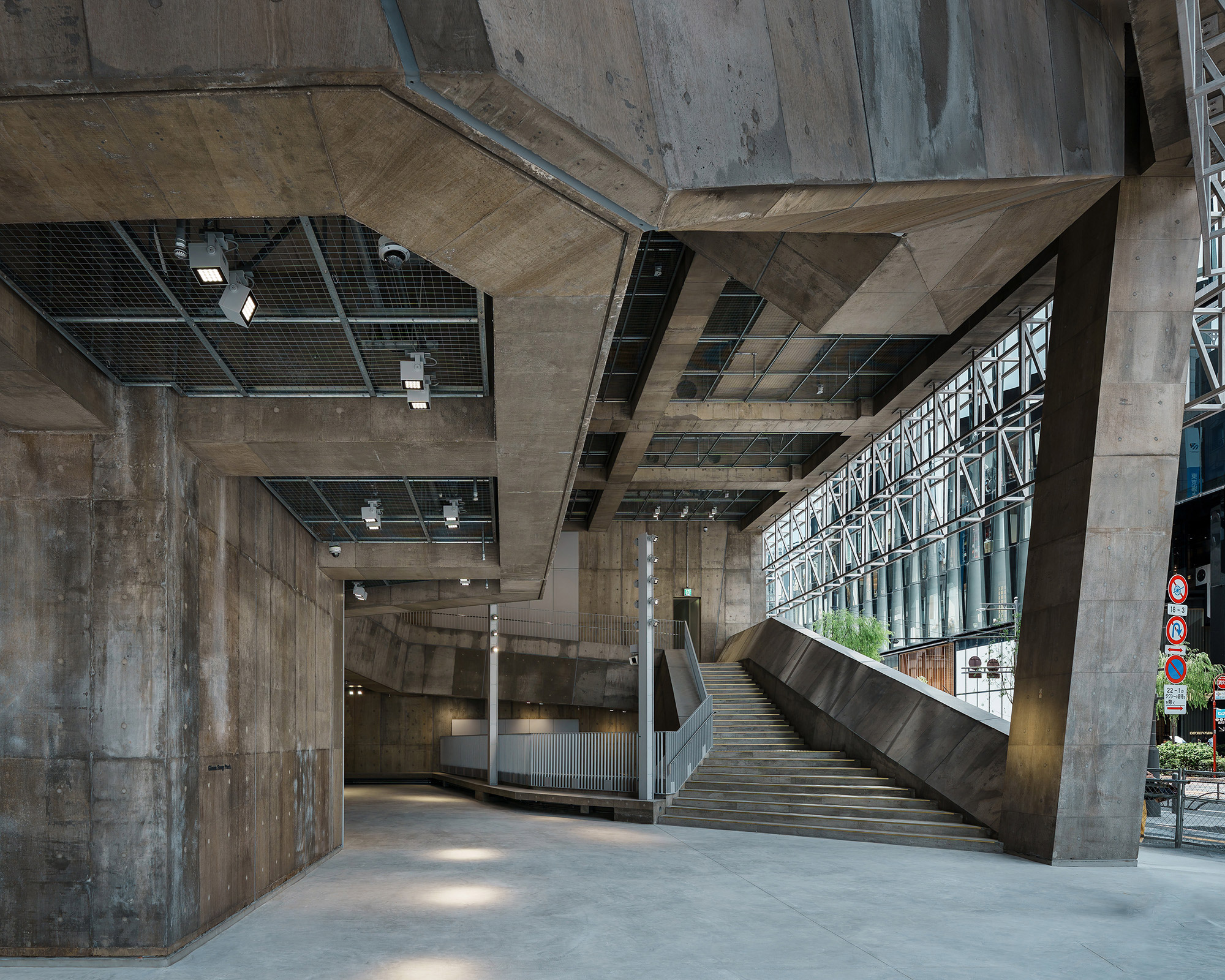 Exterior. The first floor area, which features a large staircase that leads up to the second floor, is a large atrium space that while technically inside of the building, is basically outdoors.