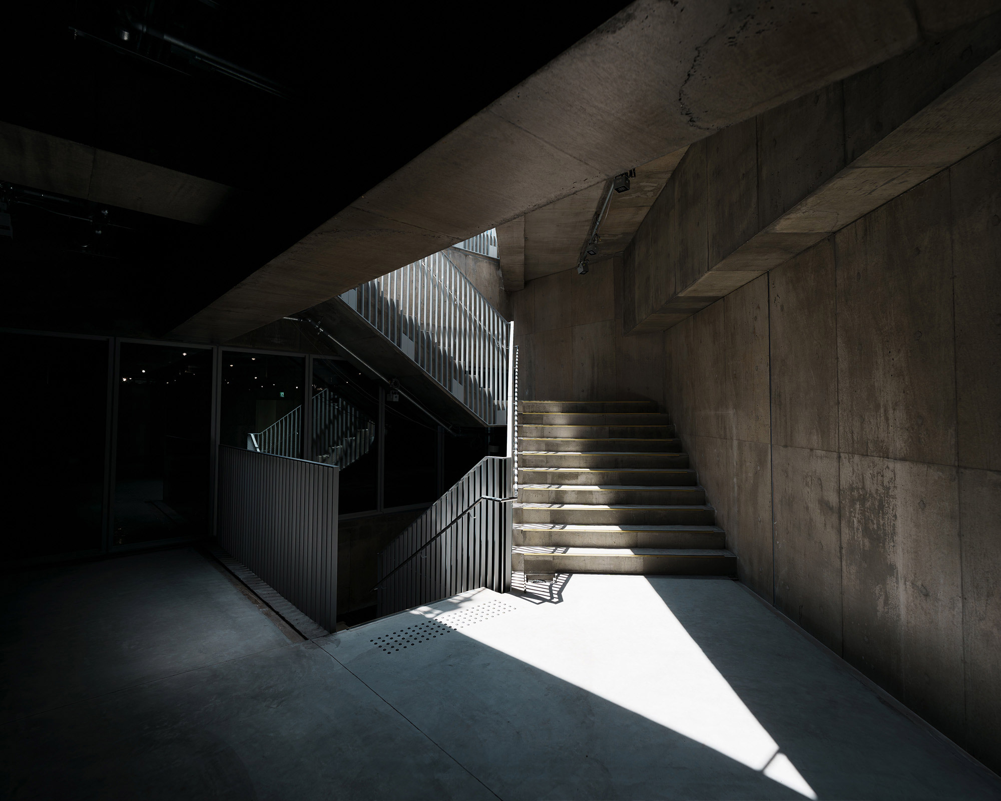 Interior. Sunlight shines through from above the stairway landing.
