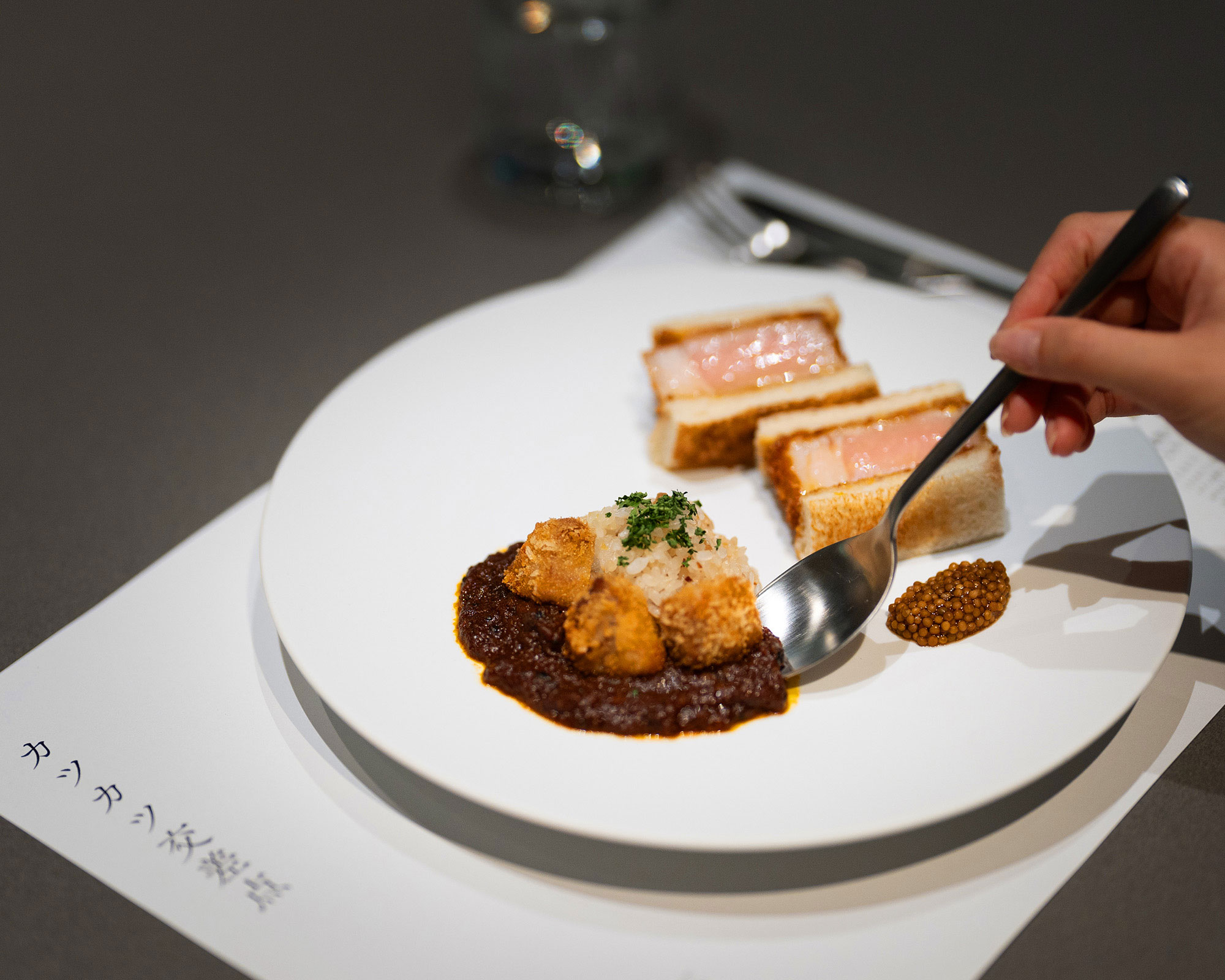 Lifting the served food with a spoon.