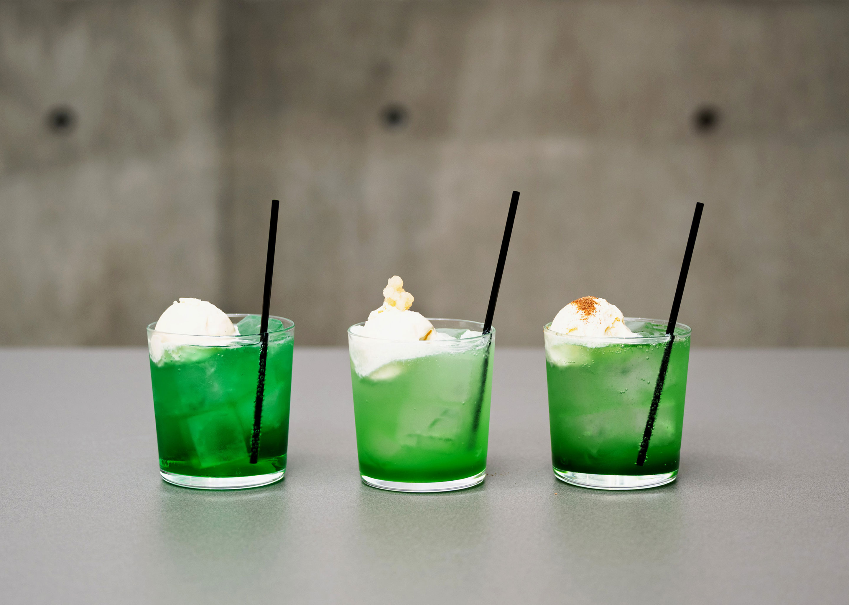 A photo of three types of melon soda topped with ice cream.