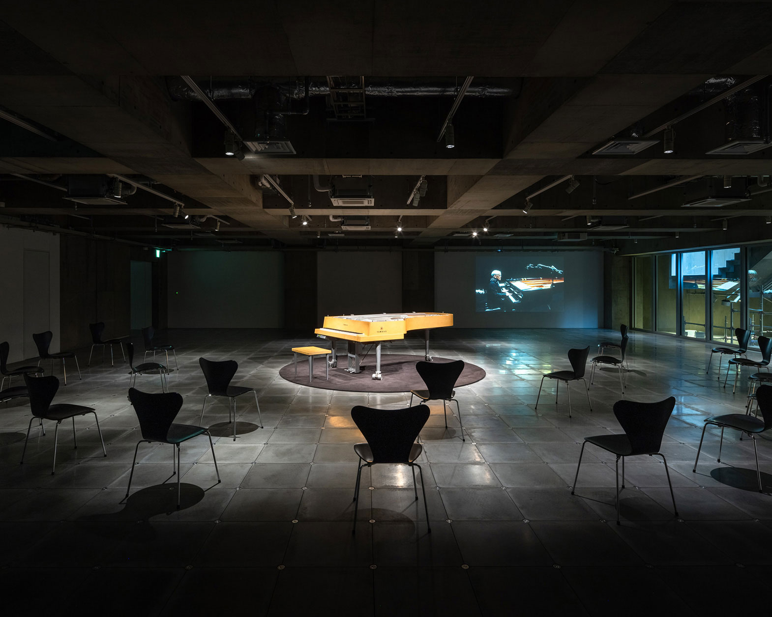 In the center of the floor, there is an "opera piano," surrounded by several chairs.