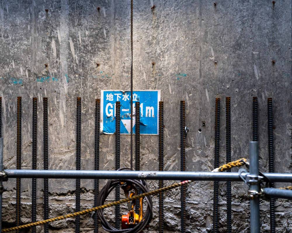 Interior. The “GL -11m” sign placed on the exterior basement wall during construction indicates the groundwater level.