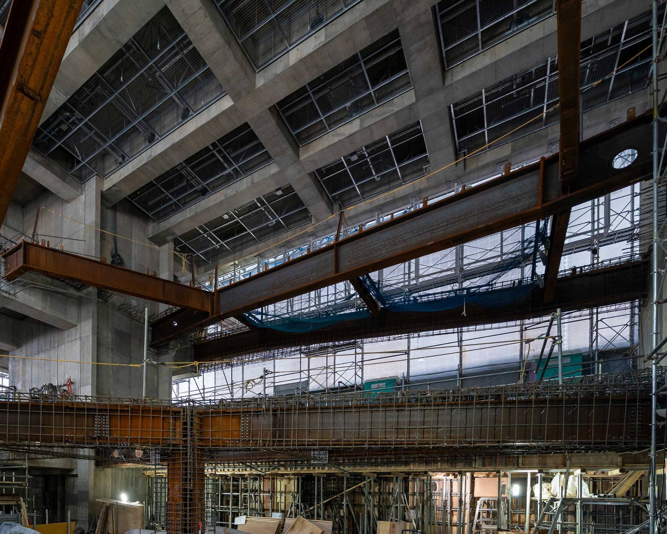 Interior. Steel frame installed in the atrium space during its construction, as seen looking up to the ceiling from the first basement floor.