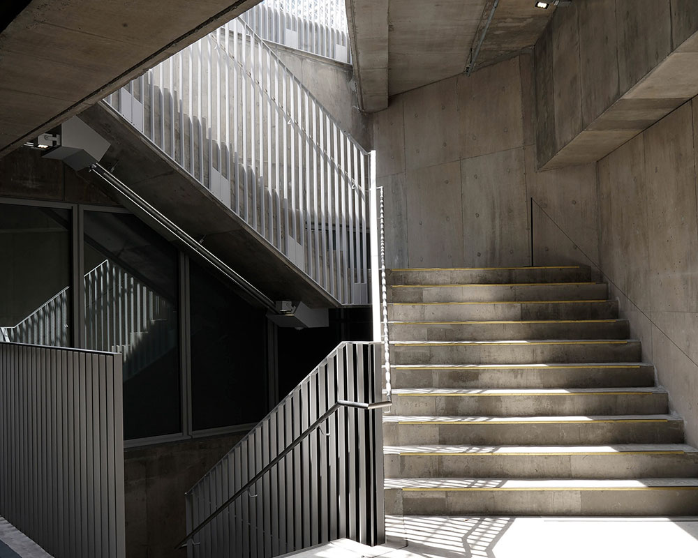 Natural light pours into the open stairwell space.