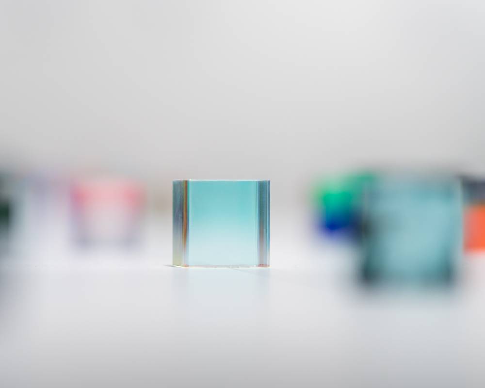 Exhibit. A display of small art objects of various colors, materials, and finishes.