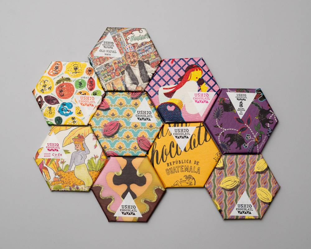 Product. An assortment of hexagonal chocolates in packages of various patterns.