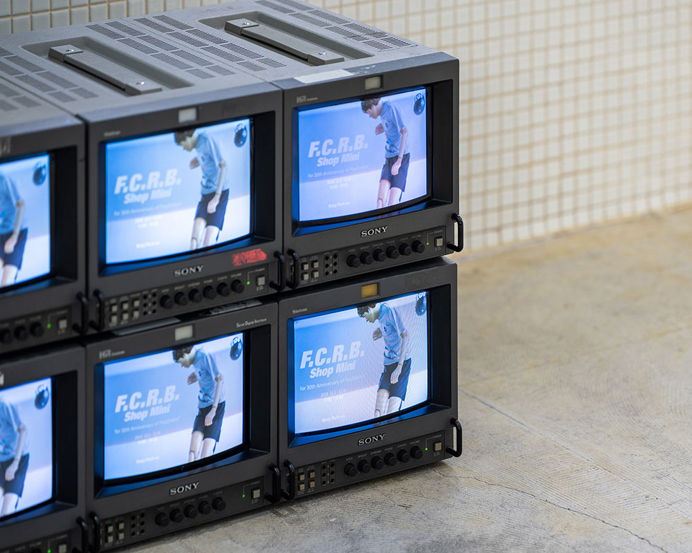 Exhibit. Four Sony monitors display visuals of F.C.R.B.