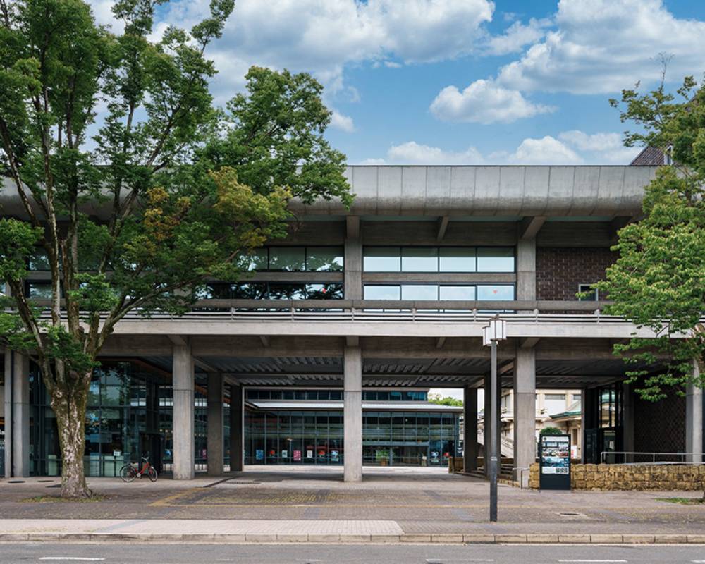 Exterior. Duck under the façade of the wide, low building, and you find yourself at the glass entrance to the venue.