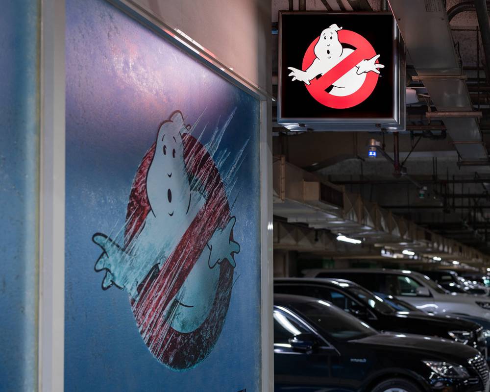 Exterior. The glass window and signboard of the exhibition space, decorated with the Ghostbusters “No ghost” mark.