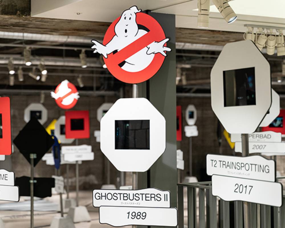 Exhibit. The exhibit monitors, which are designed to resemble traffic lights, feature movie titles and the year they were released; the occasional 