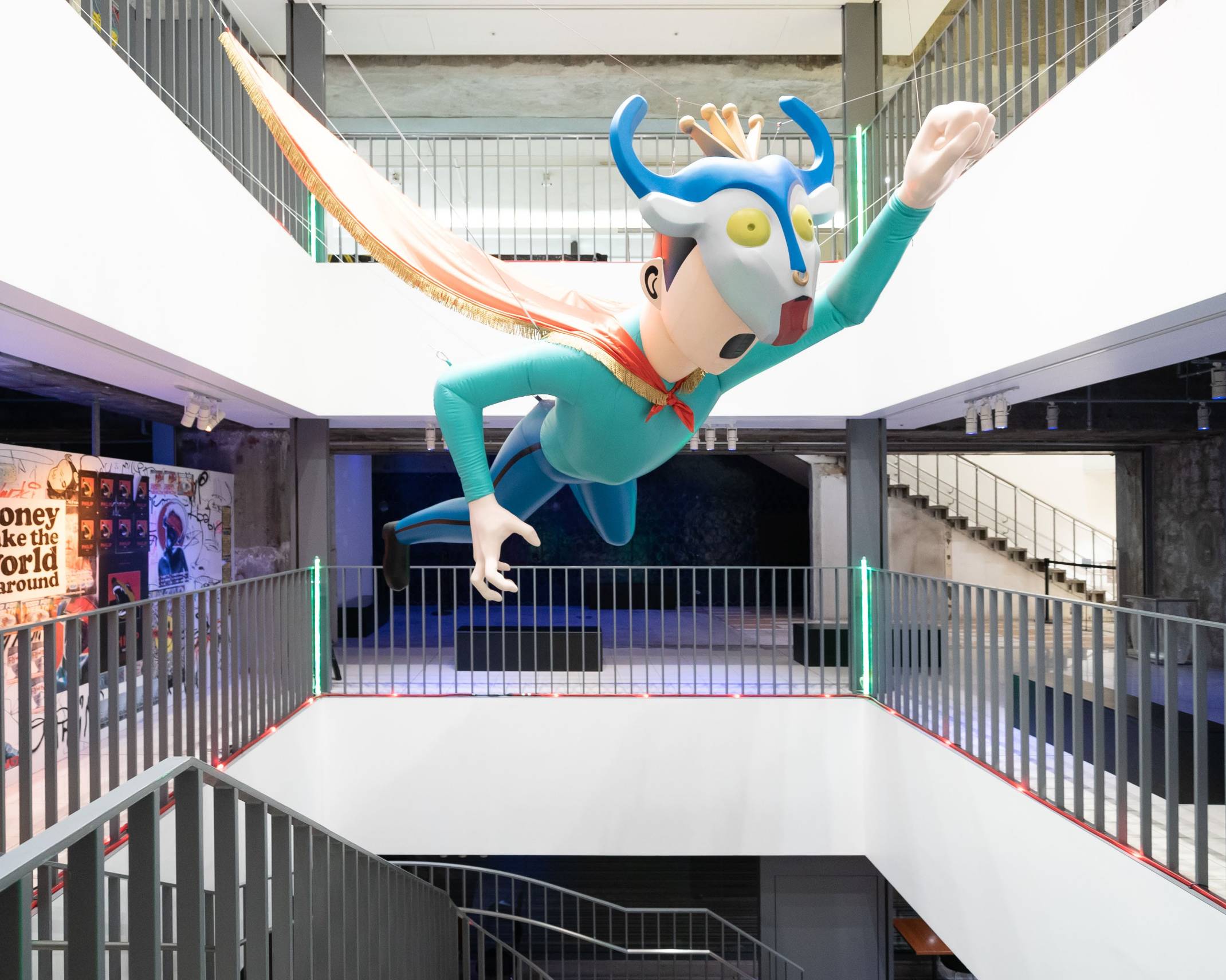 Exhibit item. A giant art object of a boy, which appears in the music video for the King Gnu song “Hikoutei,” hangs in the atrium.