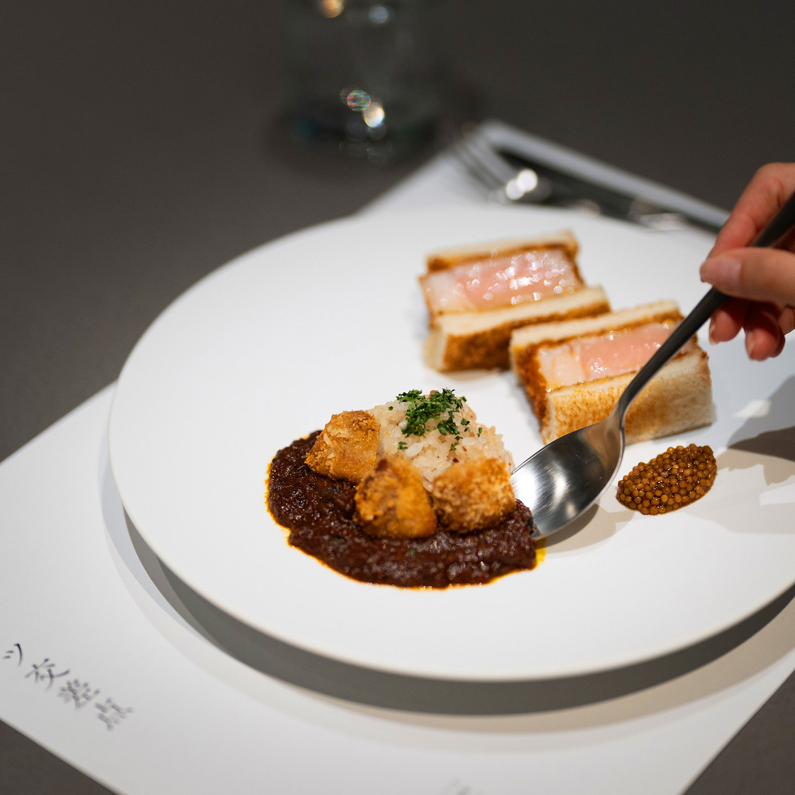 Lifting the served food with a spoon.